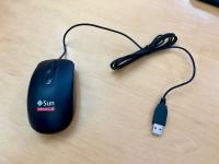 Black Sun Microsystems Oracle USB optical scroll mouse with coiled cable. 